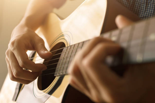 Close up of person playing guitar